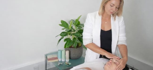 Oana expert facialist performing a bespoke at-home facial massage treatment in London, focusing on lifting sculpting and lymphatic drainage